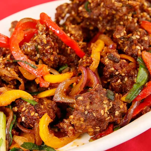 Beef Manchurian - tender beef in tangy Manchurian sauce with fried onions