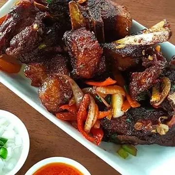 Close-up of Mister Wok Lamb Ribs — thick Dorper cut, caramelised sticky-sweet glaze, fall-tender meat on the bone